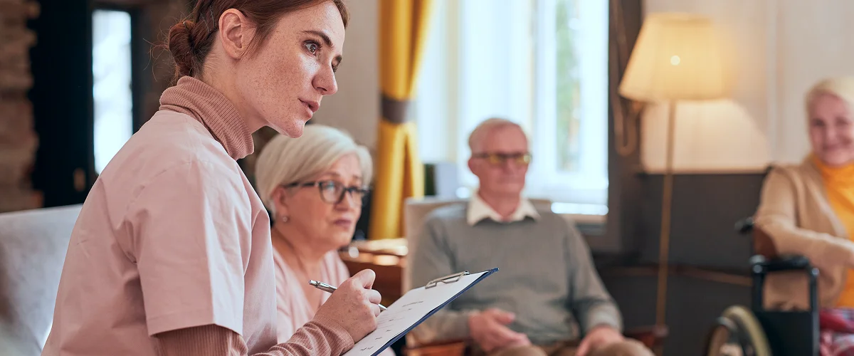 Care home staff documenting resident notes during a CQC inspection review