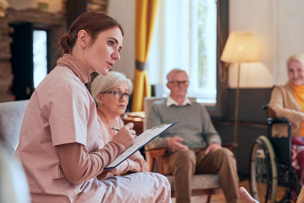 Care home staff documenting resident notes during a CQC inspection review